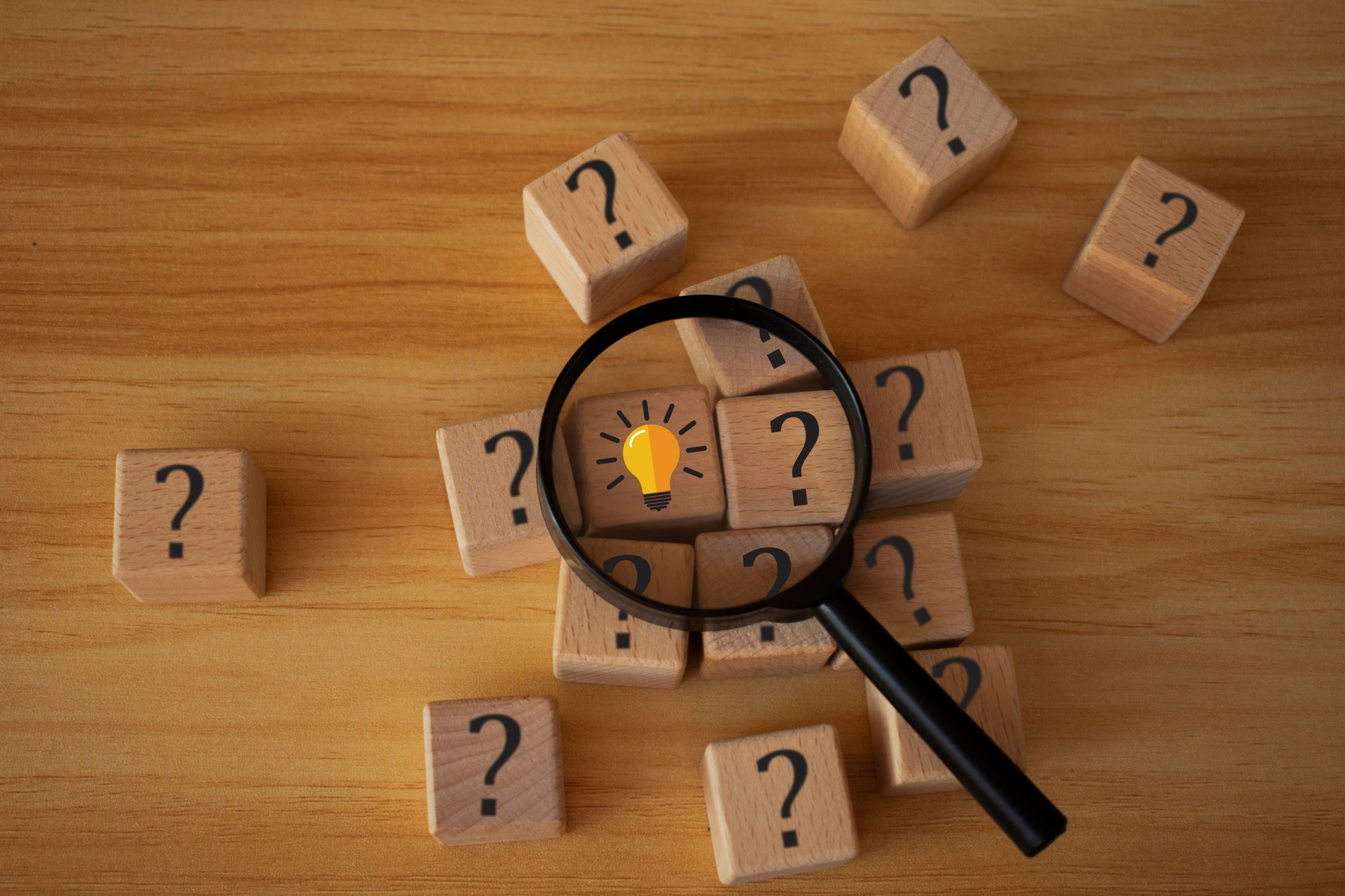 Magnifying glass with text "search" on wood cubes, find the answers, search concept, wooden cube blocks with magnifying glass, market and customer target and focusing. product review and forecast.